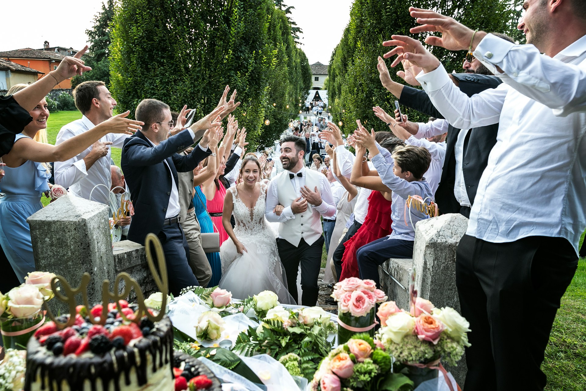 Wedding couple celebrating with confetti and guests cheering